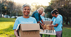 Volunteer, park and portrait of woman with box for food drive, charity event and donation. Helping, teamwork and people with package for outreach program, community service and nonprofit outdoor