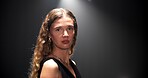 Fashion, woman and portrait of runway model in studio for glamour, chic and dark background. Face, trendy and stylish person with confidence for clothing show, designer brand and aesthetic with space
