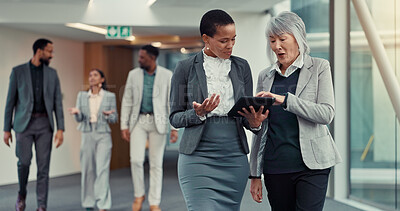 Buy stock photo Office, hallway and women with tablet, talking and criminal attorney with info for case or teamwork. Reading, research and lawyers with tech for legal evidence, discussion and planning for trial