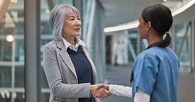 Buy stock photo Handshake, healthcare and hospital administrator with nurse in corridor for thank you or welcome. Management, medical or meeting with boss person and woman shaking hands for internship or residency