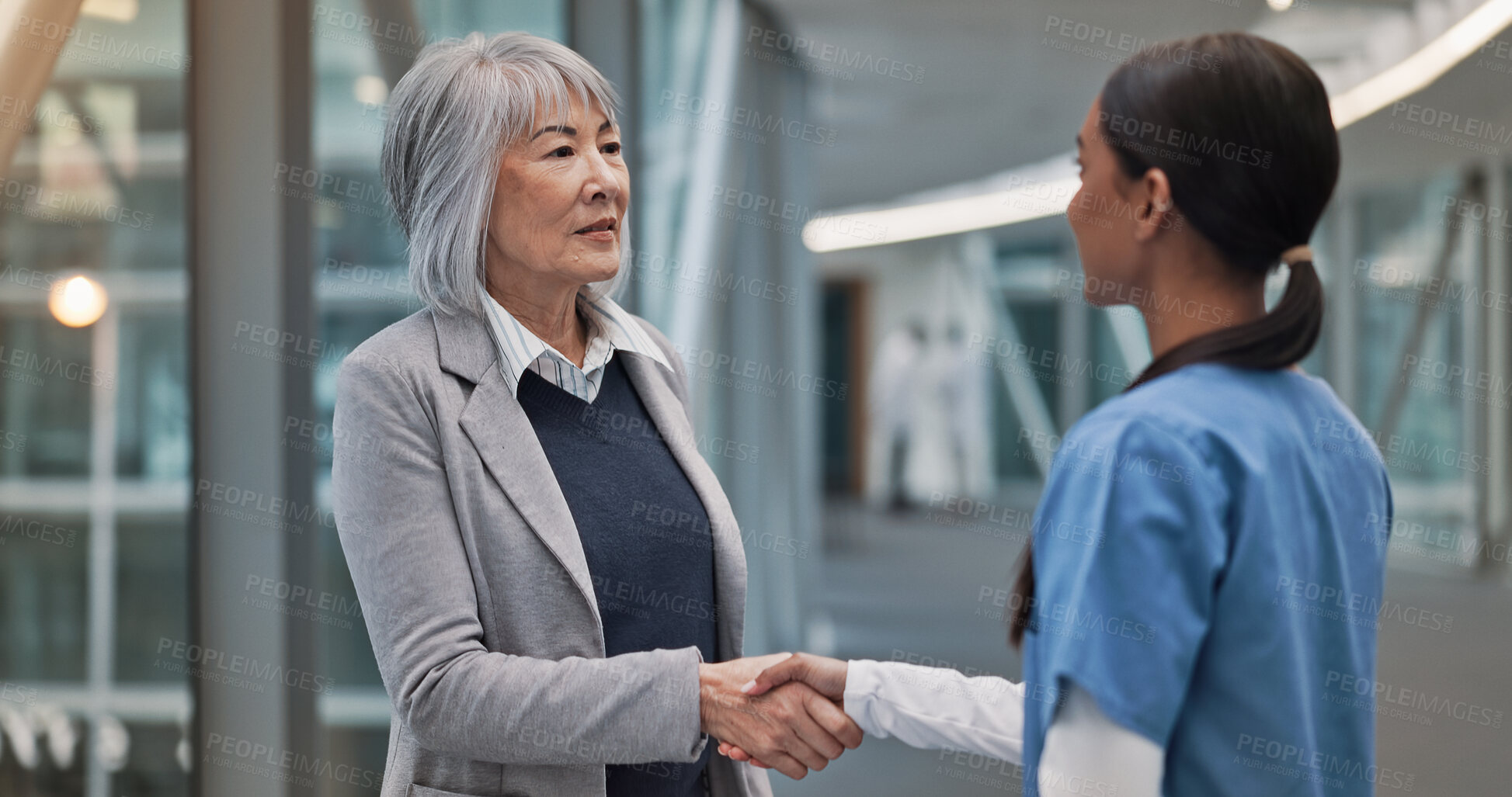 Buy stock photo Handshake, healthcare and hospital administrator with nurse in corridor for thank you or welcome. Management, medical or meeting with boss person and woman shaking hands for internship or residency