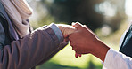 Bonding, holding hands or support with nurse and old person in park together for rehabilitation. Love, retirement or wellness with caregiver and senior patient outdoor in nature for assisted living