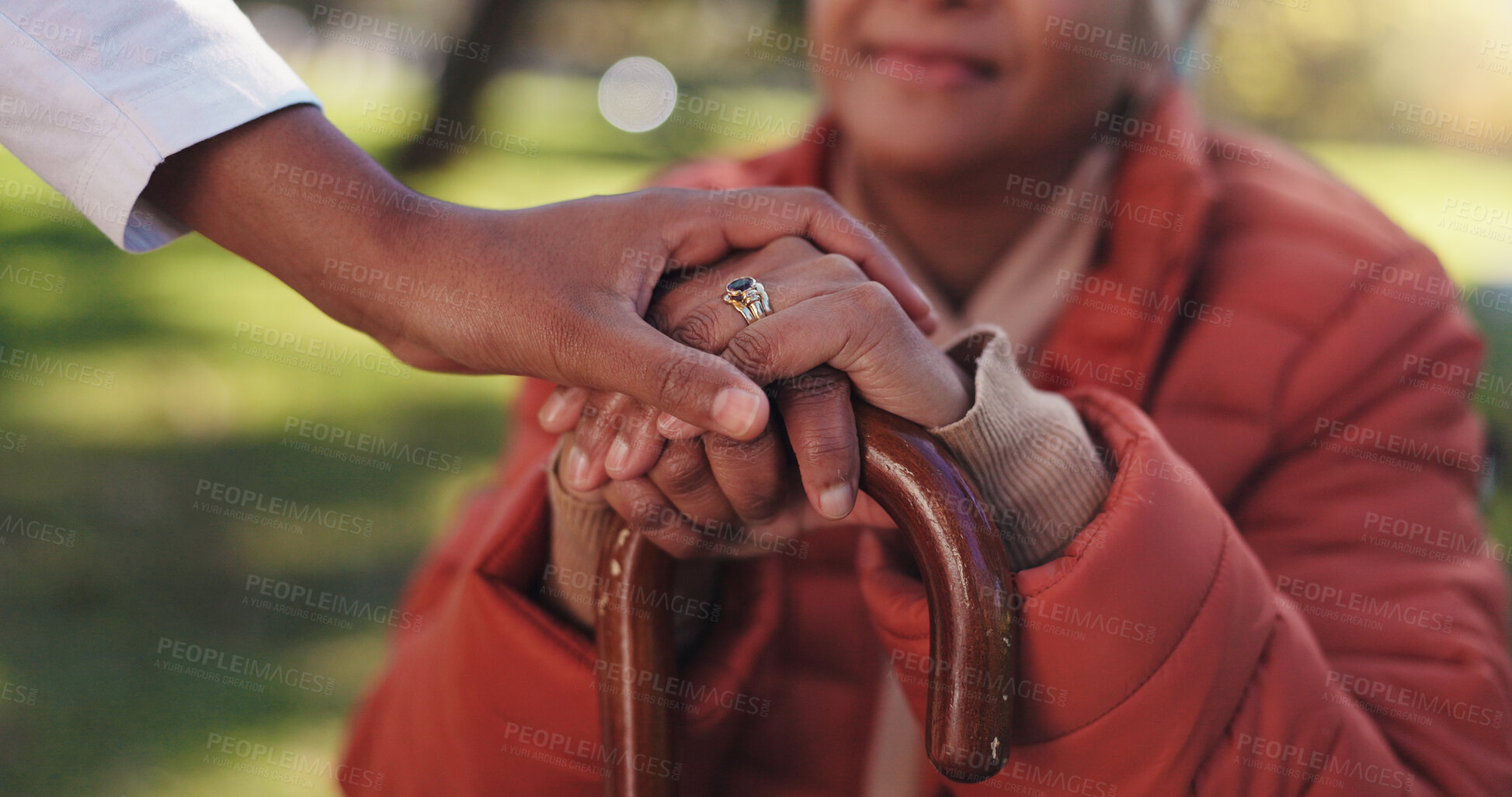 Buy stock photo Caregiver, hands together or old woman in park with walking stick, rehabilitation or support in retirement. Bokeh, parkinson or nurse in nature with cane, medical care or disability in outdoor stroll