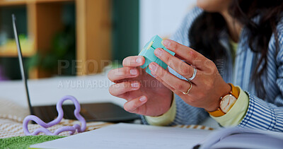 Buy stock photo Home, hands and person with fidget toy for adhd, stress or anxiety in bedroom with laptop. Sensory game, fingers and woman with autism on bed, student learning and education with cube for relax