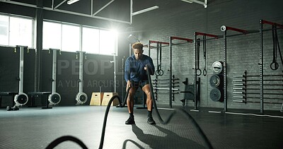 Buy stock photo Man, battle rope and workout in gym for cardio, exercise and body building for fitness. Intense routine, muscle and wellness with power for strength training, weight equipment and bicep challenge