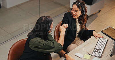 Buy stock photo Customer support, fist bump and women with headset, office and working late with new system or above. Call center, supervisor and people with tech for software troubleshooting, achievement and night