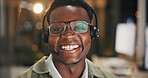 Happy, black man and night portrait with headset for online advice or customer service in office. Male person, consultant or friendly agent working late with smile for virtual assistance in workplace