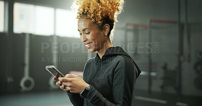 Buy stock photo Woman, gym and smile with phone for social media, message or online post and break. Happy african person, sports center and fitness with laugh on internet for funny video, meme or notification