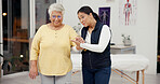 Healthcare, walking and physiotherapist with senior patient in clinic for medical consultation. Retirement, helping checkup and physical therapist with elderly person with a disability for support.