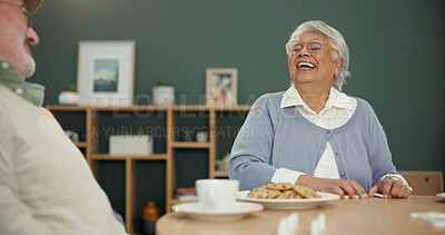 Buy stock photo Retirement, tea time and couple in house with cookies, laughing and bonding together during lunch. Happiness, old man and woman at table with biscuits, funny memory and relax in nursing home.
