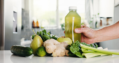 Buy stock photo Green, ingredients and hand with bottle in kitchen for detox, vitamin drink and wellness benefits. Nutrition, gut health and person in home with juice container, raw fruits and vegetable for diet