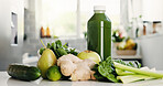 Green, ingredients and bottle in kitchen for detox, vitamin drink and wellness benefits. Nutrition, gut health and morning beverage in home with juice container, raw fruits and vegetable for diet