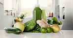 Green, ingredient and smoothie with bottle in kitchen for detox, vitamin drink and wellness benefits. Nutrition, gut health and beverage in home with juice container, raw fruits or vegetable for diet