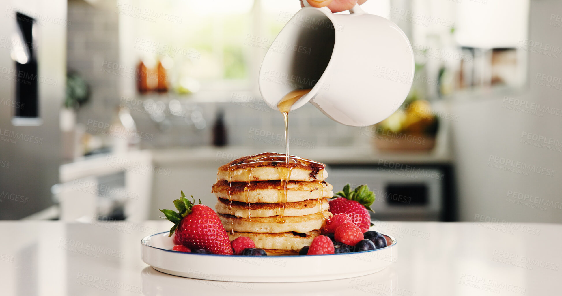 Buy stock photo Hands, person and syrup with pancakes at house for meal prep, homemade breakfast and nutrition. Pour, honey and strawberry on fruit for sweet treat, brunch dessert and hotcakes snack on table in home