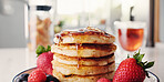 Pancakes, strawberries and syrup with meal in kitchen of home for hunger, nutrition or snack. Breakfast, food and fruit with organic pastry in apartment for culinary or gourmet dish presentation