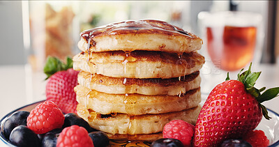 Buy stock photo Breakfast, pancakes and strawberries with meal in kitchen of home for hunger, nutrition or snack. Food, fruit and syrup with organic pastry in apartment for culinary or gourmet dish presentation