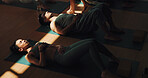 Breathing, meditation and yoga woman on floor in class for stress relief or wellness with coach. Above, exercise or shade with yogi people and personal trainer in studio for awareness or balance