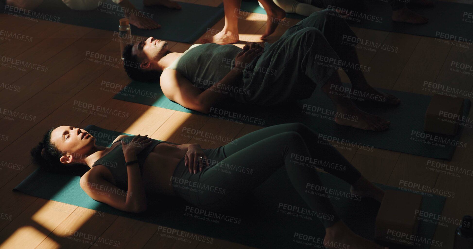 Buy stock photo Breathing, meditation and yoga woman on floor in class for stress relief or wellness with coach. Above, exercise or shade with yogi people and personal trainer in studio for awareness or balance