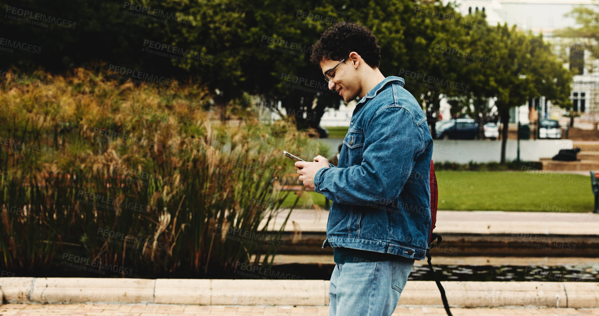 Buy stock photo University, walking and man with phone for social media, networking and online message on campus. College, academy and student on smartphone for connection, internet or website on journey to class