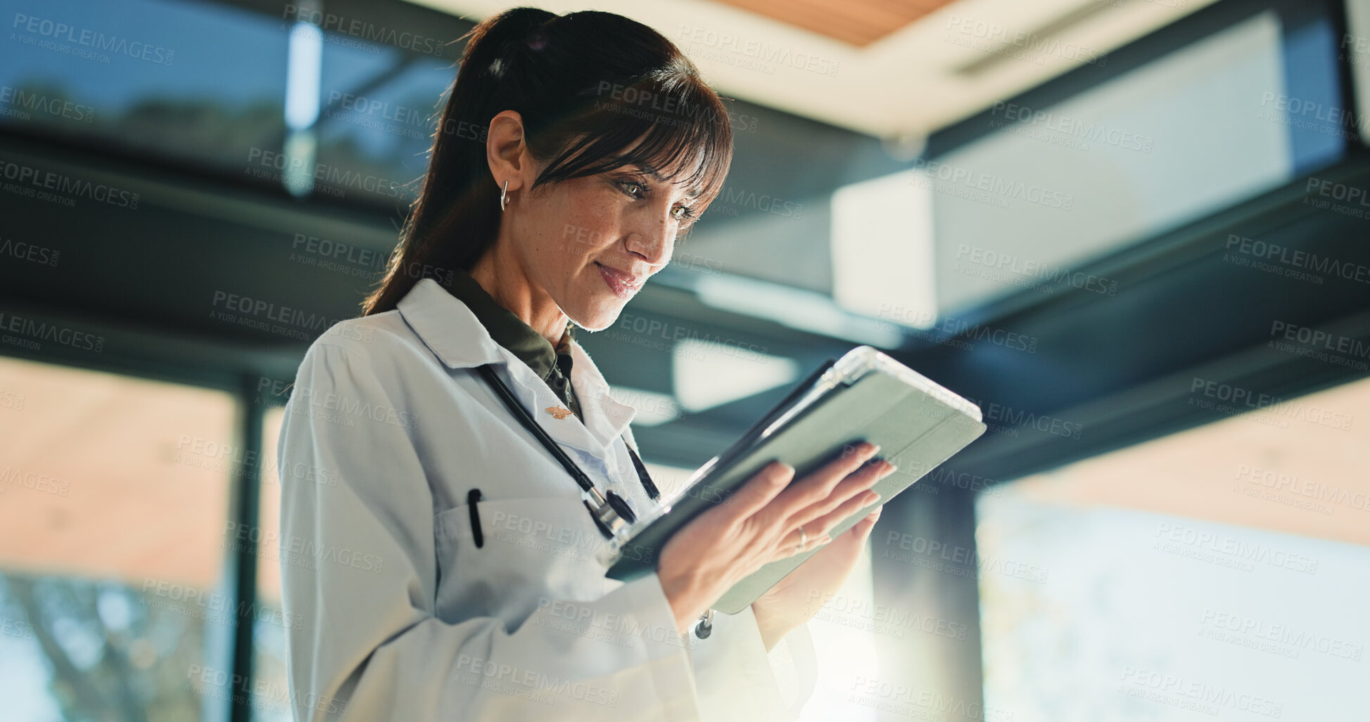 Buy stock photo Smile, doctor and woman with tablet for healthcare info, report or telehealth in clinic. Technology, medical professional and mature person in hospital with insurance records, email or research