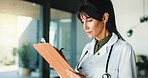 Doctor, mature woman or review with clipboard in clinic, medical report or writing instructions for care plan. Healthcare, patient treatment or person reading chart for info, lab results or low angle