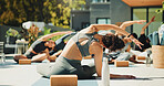 Woman, trainer and yoga class for fitness, stretching or back at wellness retreat. Yogi, group exercise and people with instructor at resort for balance, healing and health with side bend outdoor