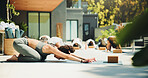 Yoga, stretching and personal trainer with group, class and routine to improve posture and endurance. Outdoor, people and balance for child pose at wellness center, self awareness and flexibility