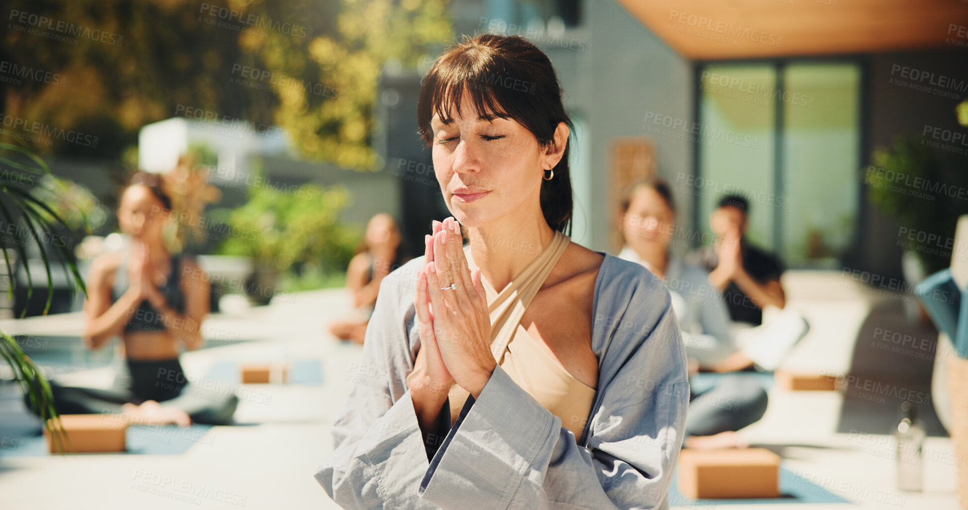 Buy stock photo Yoga class, instructor and people at resort with prayer hands, meditation or chakra healing. Group, coach or woman outdoor in wellness retreat with mudra for mindfulness, inner peace or namaste pose.