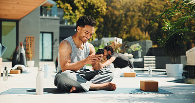 Buy stock photo Yoga, smile and phone with man in class for spiritual retreat, social media and communication. Pilates workout app, wellness club and online mindfulness guide with person outdoor for fitness