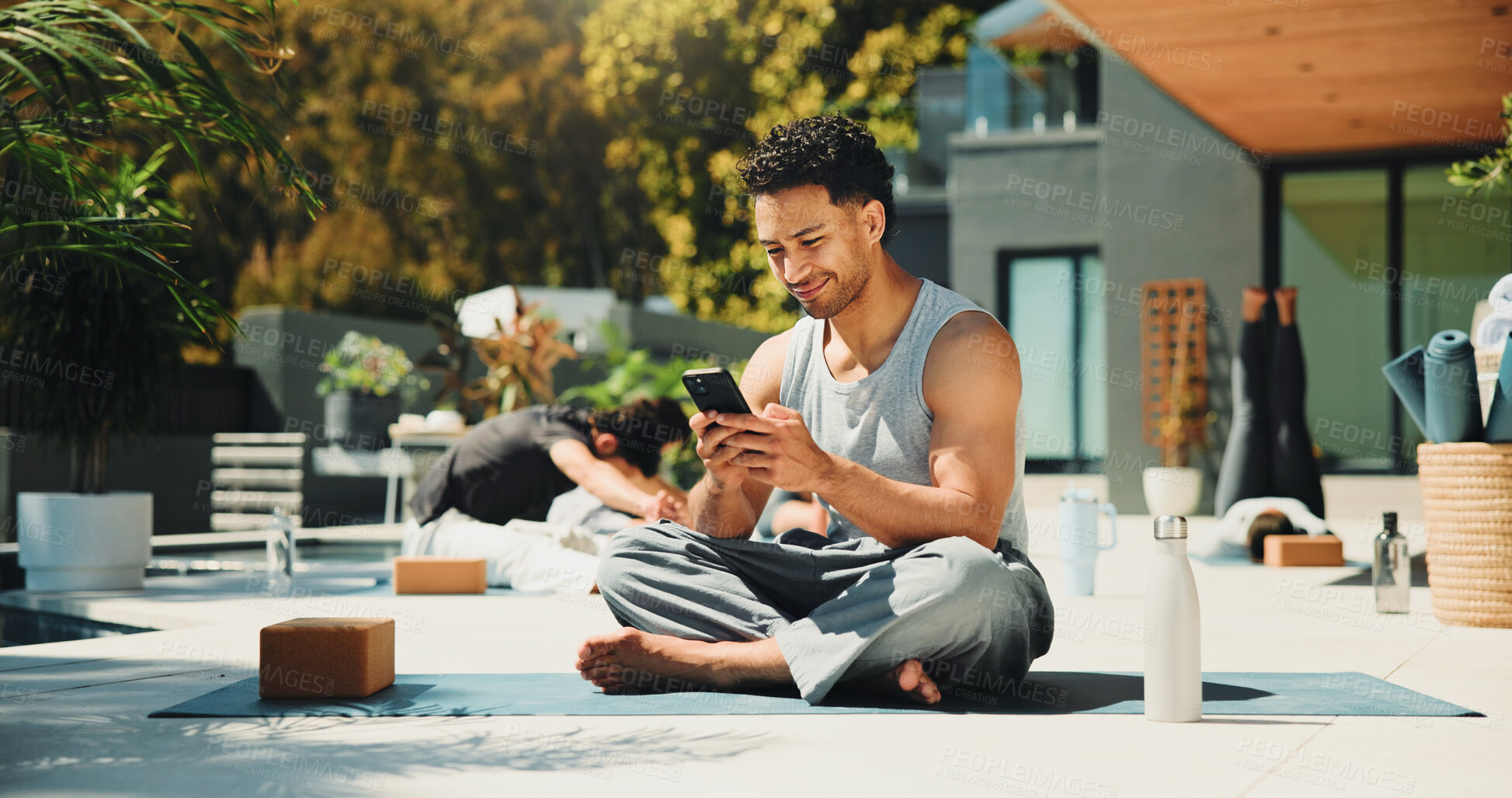 Buy stock photo Yoga, reading and phone with man in class for spiritual retreat, social media and communication. Pilates workout app, wellness club and online mindfulness guide with person outdoor for fitness