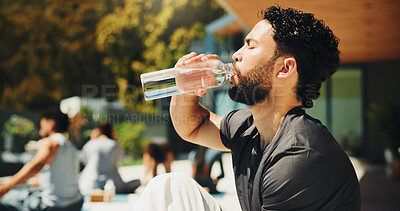 Buy stock photo Drinking, outdoor and man with water at pilates class for break, relax or recovery on wellness retreat. Calm, rest and male person with healthy beverage for hydration at yoga session on holiday.