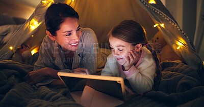 Buy stock photo Night, mother or child with tablet in tent for bonding together, reading ebook or bedtime story. Happy, parent or daughter with tech in home for online fairytale, kids storytelling app or literature.