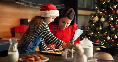 Buy stock photo Christmas, mother or child in kitchen with icing, baking help or bonding in holiday season. Happy, festive or family in house with cookie preparation, support or sweet treat frosting for Santa.