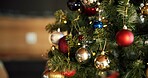 Christmas, decoration and wallpaper with balls on tree in home for celebration, event or tradition. Background, festive and holiday with baubles in apartment for aesthetic, vacation or winter season