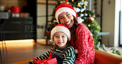 Buy stock photo Portrait, Christmas and mother with child on couch, holiday happiness and festive season in family home. Xmas, December time and woman with daughter to open present, gift giving and excited smile