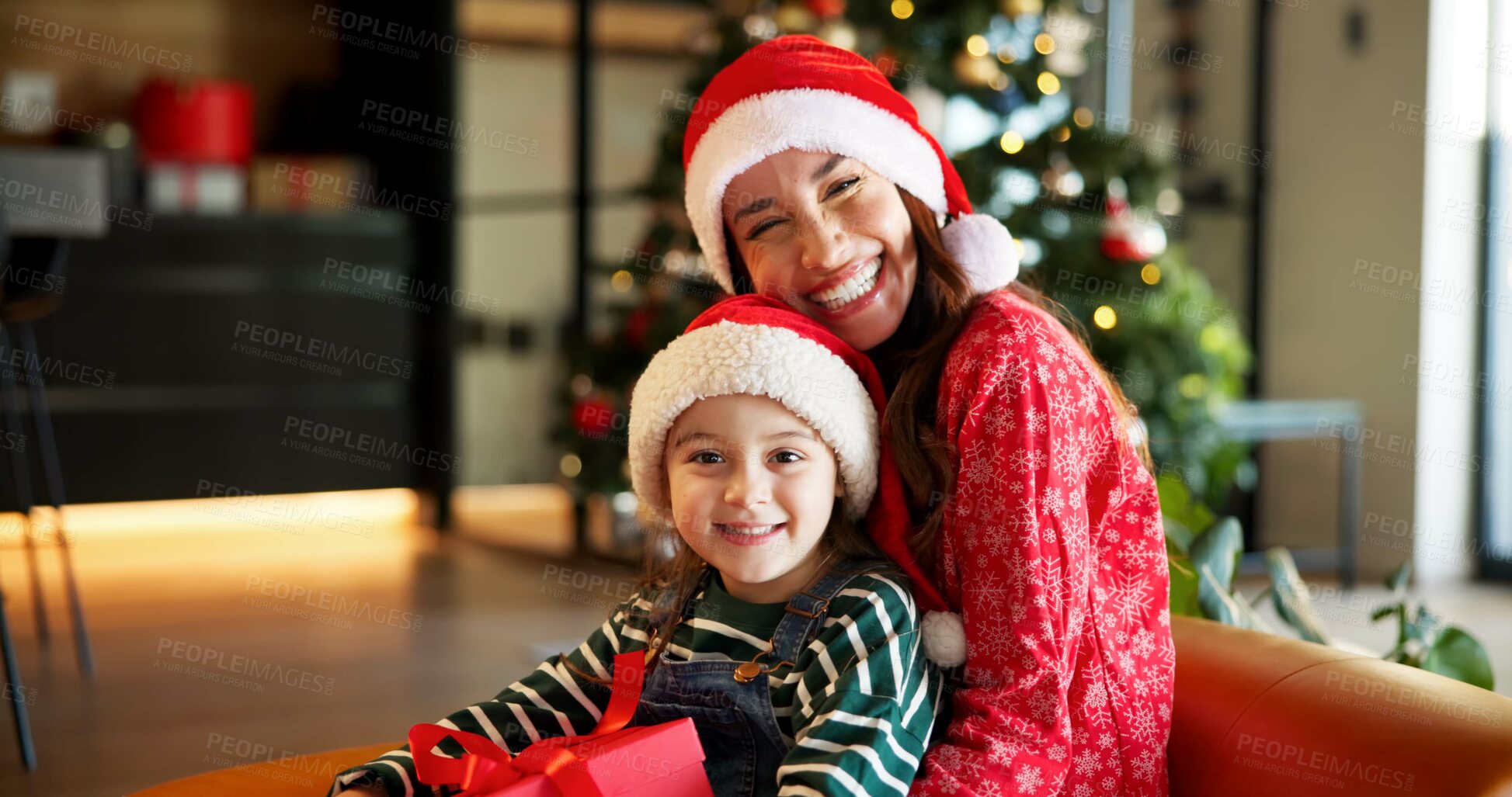 Buy stock photo Portrait, Christmas and mother with child on couch, holiday happiness and festive season in family home. Xmas, December time and woman with daughter to open present, gift giving and excited smile
