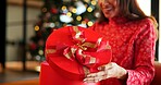 Christmas present, box and hands of woman in home living room for celebration, holiday or tradition. Excited, opening gift and surprise with happy person in apartment for December or winter season