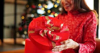 Buy stock photo Christmas present, box and hands of woman in home living room for celebration, holiday or tradition. Excited, opening gift and surprise with happy person in apartment for December or winter season