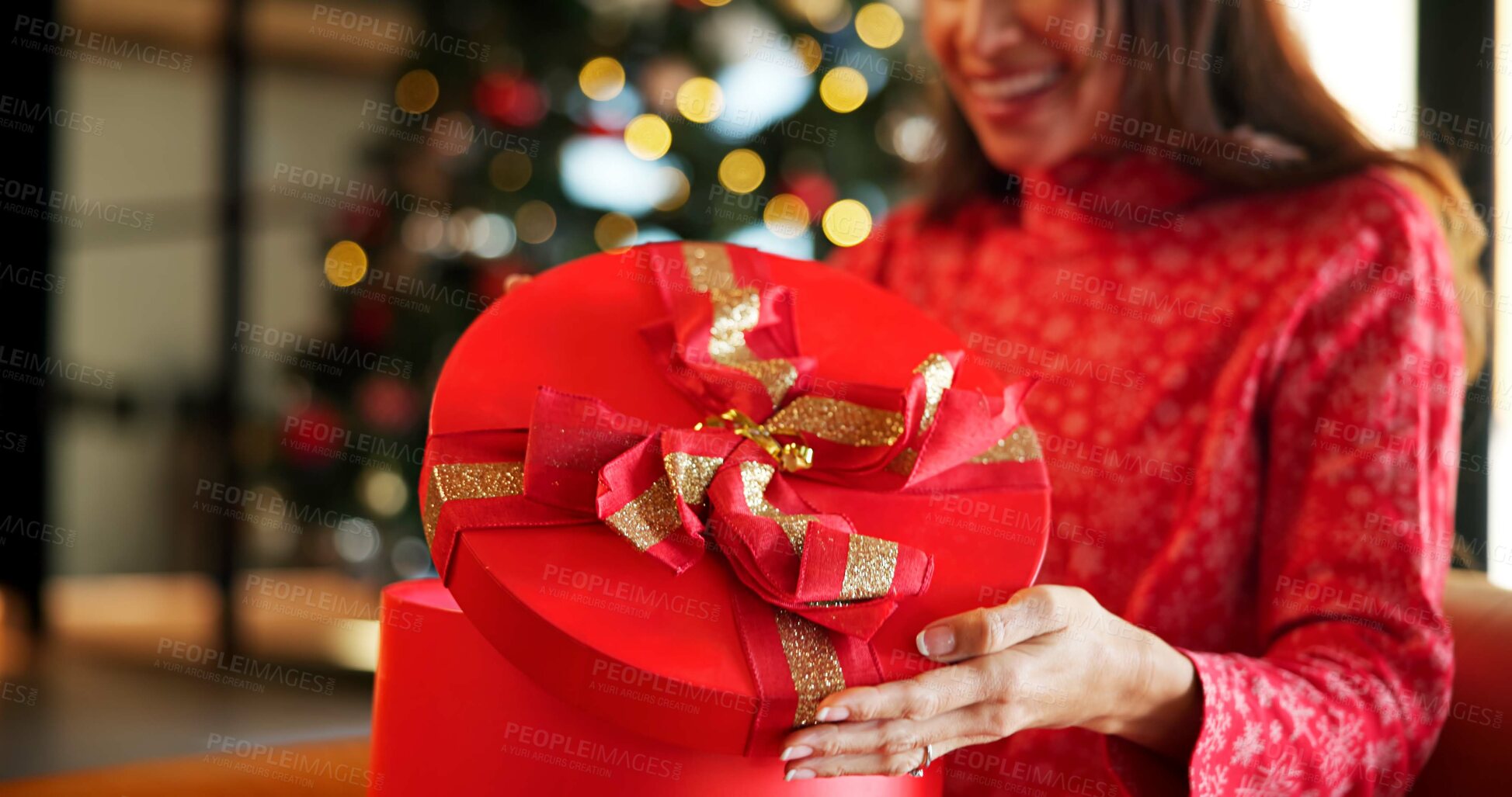 Buy stock photo Christmas present, box and hands of woman in home living room for celebration, holiday or tradition. Excited, opening gift and surprise with happy person in apartment for December or winter season