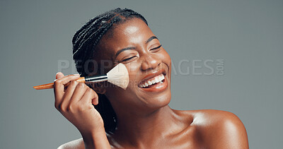 Buy stock photo Black woman, brush and happy in studio for makeup, contouring and confident with beauty. Female person, cosmetology and blush tool on gray background for blending, cosmetic application or laughing