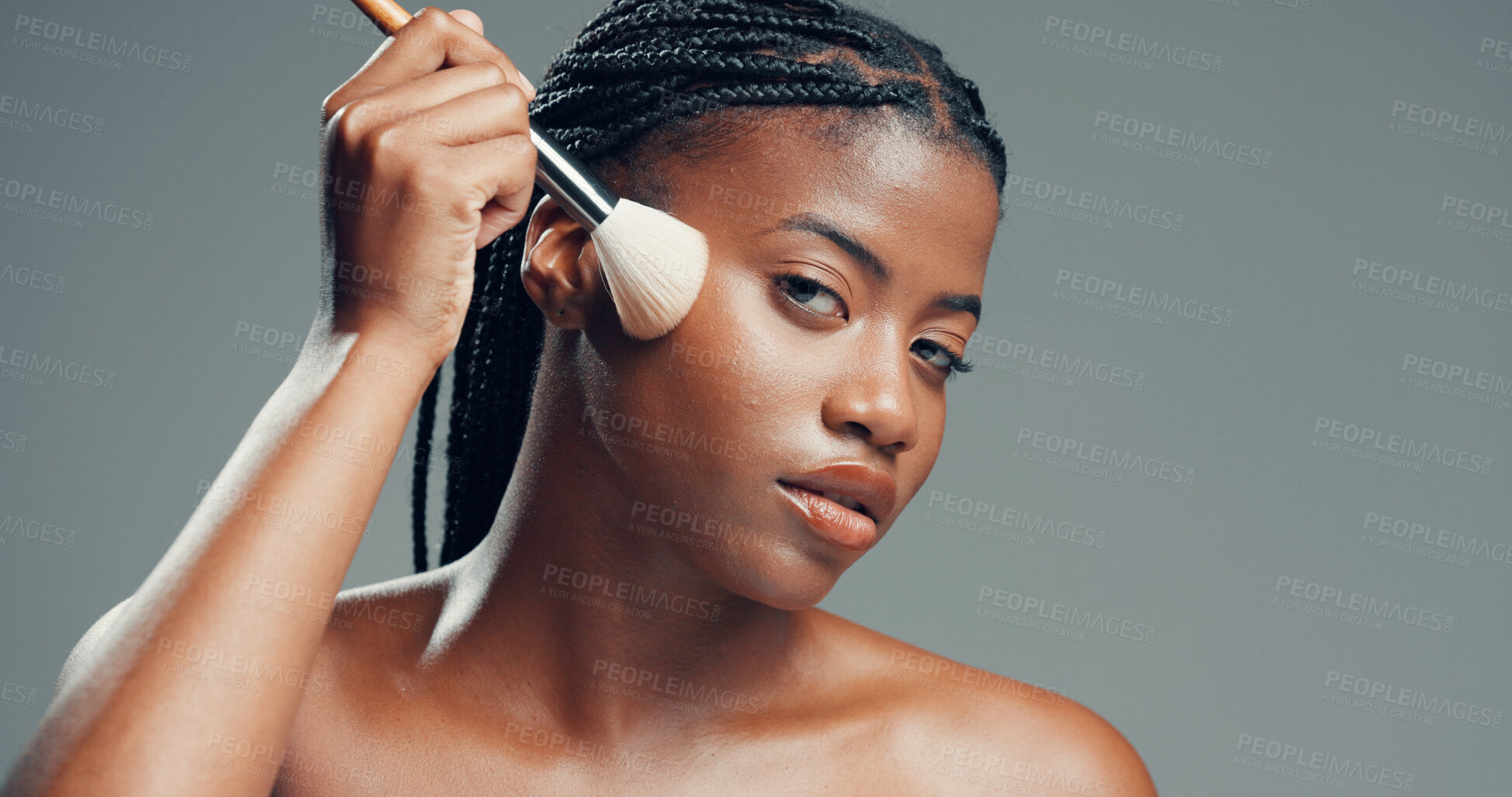 Buy stock photo Makeup, aesthetic and portrait of black woman with brush in studio for beauty, foundation or glow. Face, apply cosmetics or model with product for makeover, change and powder on gray background space