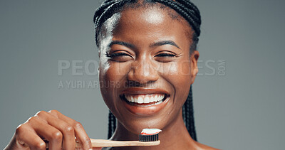 Buy stock photo Bamboo toothbrush, dental wellness and happy woman with  oral health, fresh breath and gum care. Toothpaste, portrait and excited black person with natural orthodontics in studio on gray background