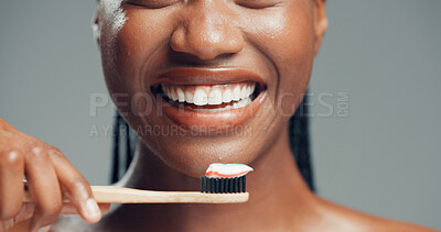 Buy stock photo Bamboo toothbrush, dental health and happy woman in studio, fresh breath and gum care. Toothpaste, eco friendly and hand of black person with oral hygiene, whitening or wellness on gray background