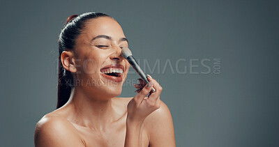 Buy stock photo Woman, brush and excited in studio for makeup, contouring and tickle nose with beauty. Person, cosmetics and blush tool on gray background space for blending, application and laughing with manicure