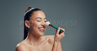 Buy stock photo Woman, brush and laugh in studio for makeup, contouring and tickle nose with beauty. Person, cosmetics and blush tool on gray background space for blending, application and excited with manicure