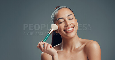 Buy stock photo Makeup, brush and and woman in studio for cosmetics, contouring and beauty treatment. Happy, blush and female person with tool for blending, application and cosmetology routine by gray background.