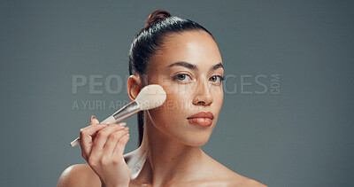 Buy stock photo Woman, brush and portrait in studio for makeup, contouring and confident with beauty. Person, cosmetology and blush tool on gray background for blending, cosmetic application or serious with manicure