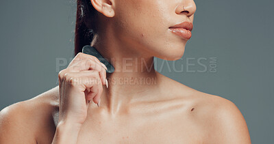 Buy stock photo Skincare, neck or woman in studio with gua sha, facial benefits or massage in self care. Cosmetology, body tone and girl on gray background with tool, sculpting or lymphatic drainage for firm skin.