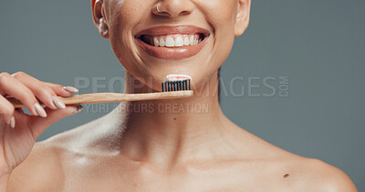 Buy stock photo Dental health, hand and woman bamboo toothbrush for oral wellness, fresh breath and gum care. Toothpaste, teeth and person with eco friendly tool for sustainable hygiene in studio on gray background