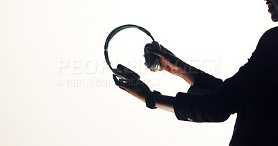 Buy stock photo Hands, person and headphones promotion in studio for audio, streaming music and sound equipment. Mockup space, brand ambassador or advertising accessory on white background for podcast, radio or song